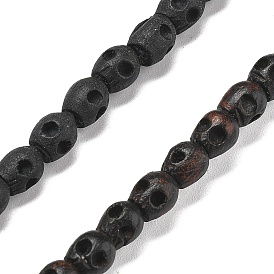 Нити резных деревянных бусин, череп