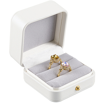 Cajas cuadradas para guardar anillos de pareja en imitación de piel, con interior de terciopelo y detalles dorados.