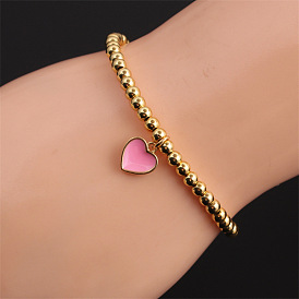 Fashionable Elastic Heart-shaped Women's Bracelet with Copper Plated Real Gold and Oil Dripping Peach Heart Beads.
