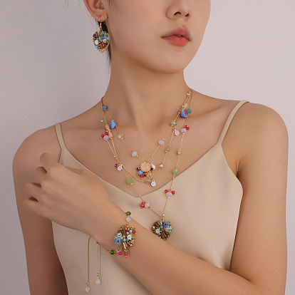 Комплекты из латунных сердечек и многослойных подвесок в технике лэмпворк, а также серег-подвесок и браслетов с подвесками