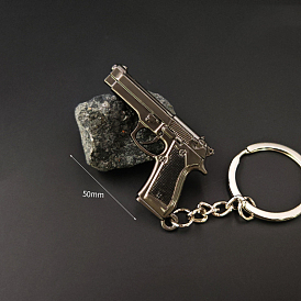 Llavero de aleación, amuleto de pistola, con anillos