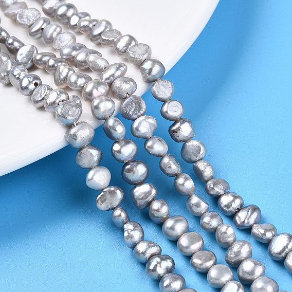 Нити из натурального культивированного пресноводного жемчуга, двух сторон полированной, окрашенные