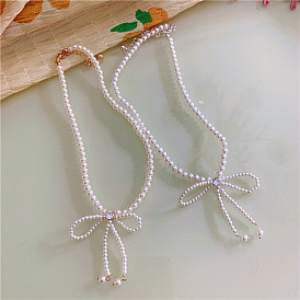Collier chic en perles avec nœud papillon pour femme - chaîne ras de cou élégante au charme vintage