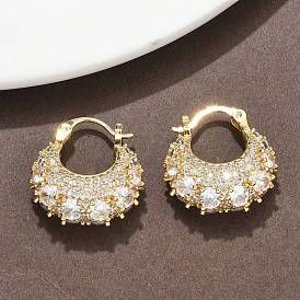 Массивные серьги-кольца из латуни с микропаве и прозрачными кубическими циркониями.