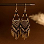 Винтажные богемные серьги-люстры с кисточками, украшенные бусинами из сплава и смолы.