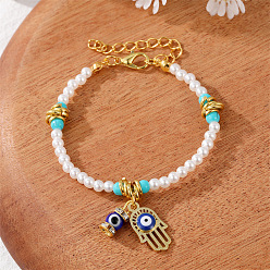 Two gold pendants with white and green pearls. Colorful Pearl Flower Bracelet with Unique Design and Handmade Beads