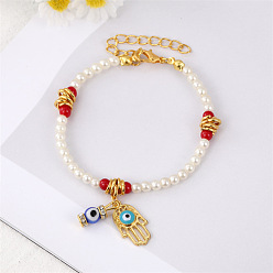 Two gold pendants with white and red beads. Colorful Pearl Flower Bracelet with Unique Design and Handmade Beads