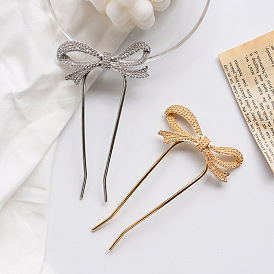 Minimalist U-shaped hairpin with butterfly knot for bun hairstyle.
